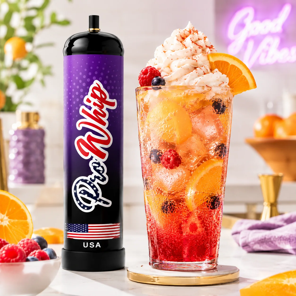 Colourful fruit drink topped with cream beside a ProWhip canister